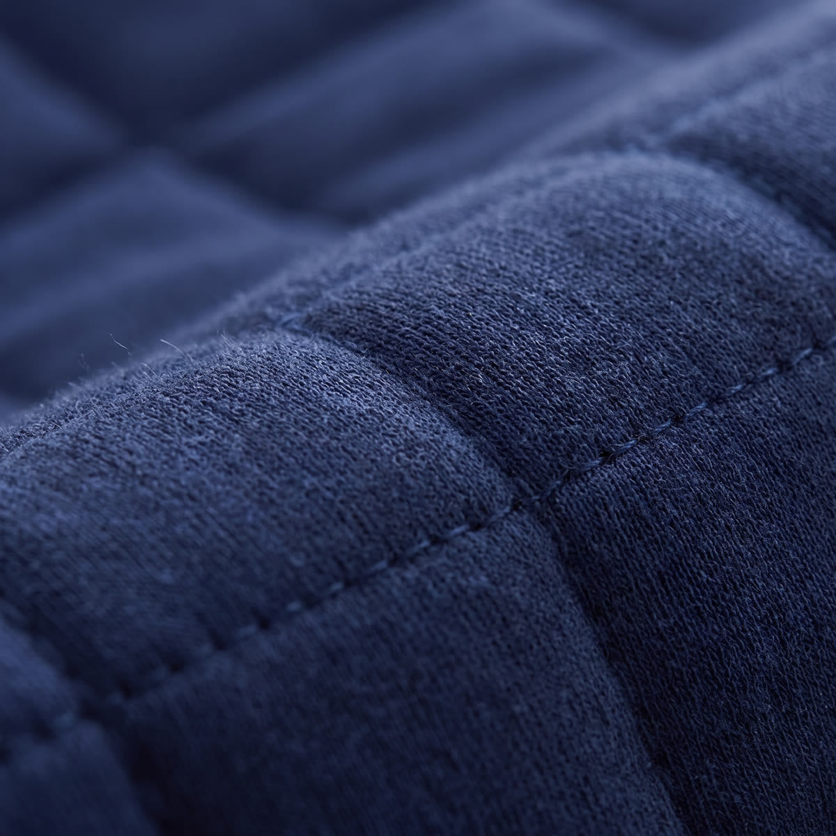 Close-up of the Wova Rest pillow quilted cover, navy blue